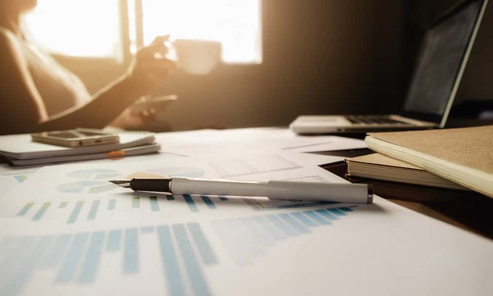 business-concept-with-copy-space-office-desk-table-with-pen-focus-analysis-chart-computer-notebook-cup-coffee-desk-vintage-tone-retro-filter-selective-focus