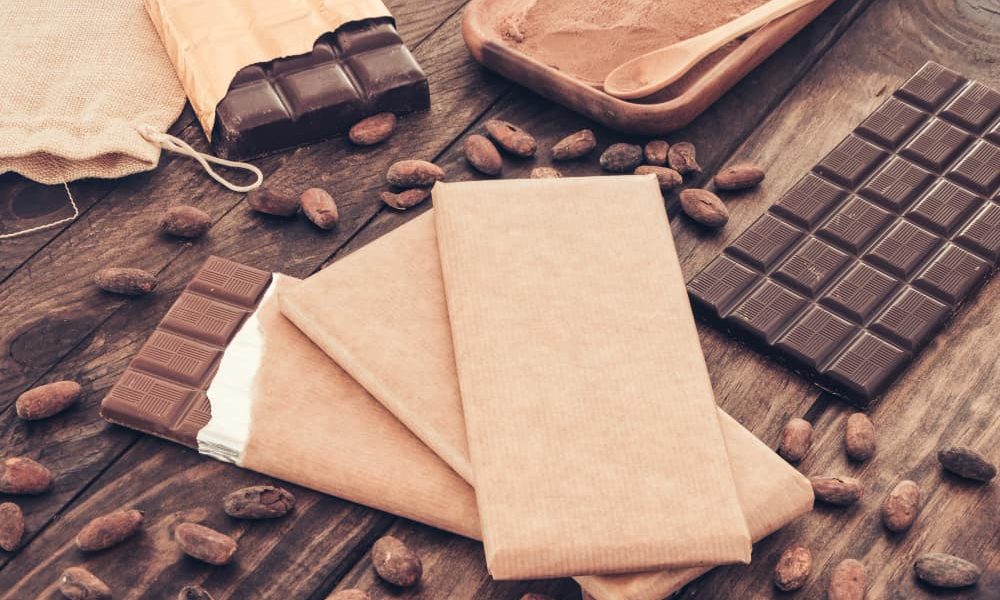dark-chocolate-bars-with-cocoa-beans-wooden-table