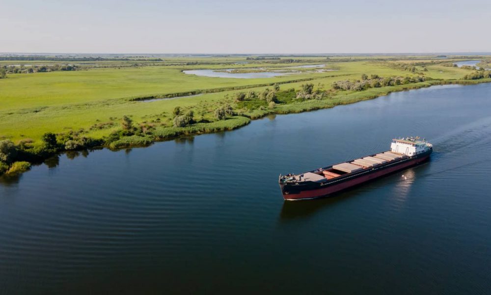 Grain carrier in the sea goes along the Dnieper. Delivery of wheat worldwide. Ship logistics during the war in Ukraine. Turkish corridor in Ukraine for the import of grain